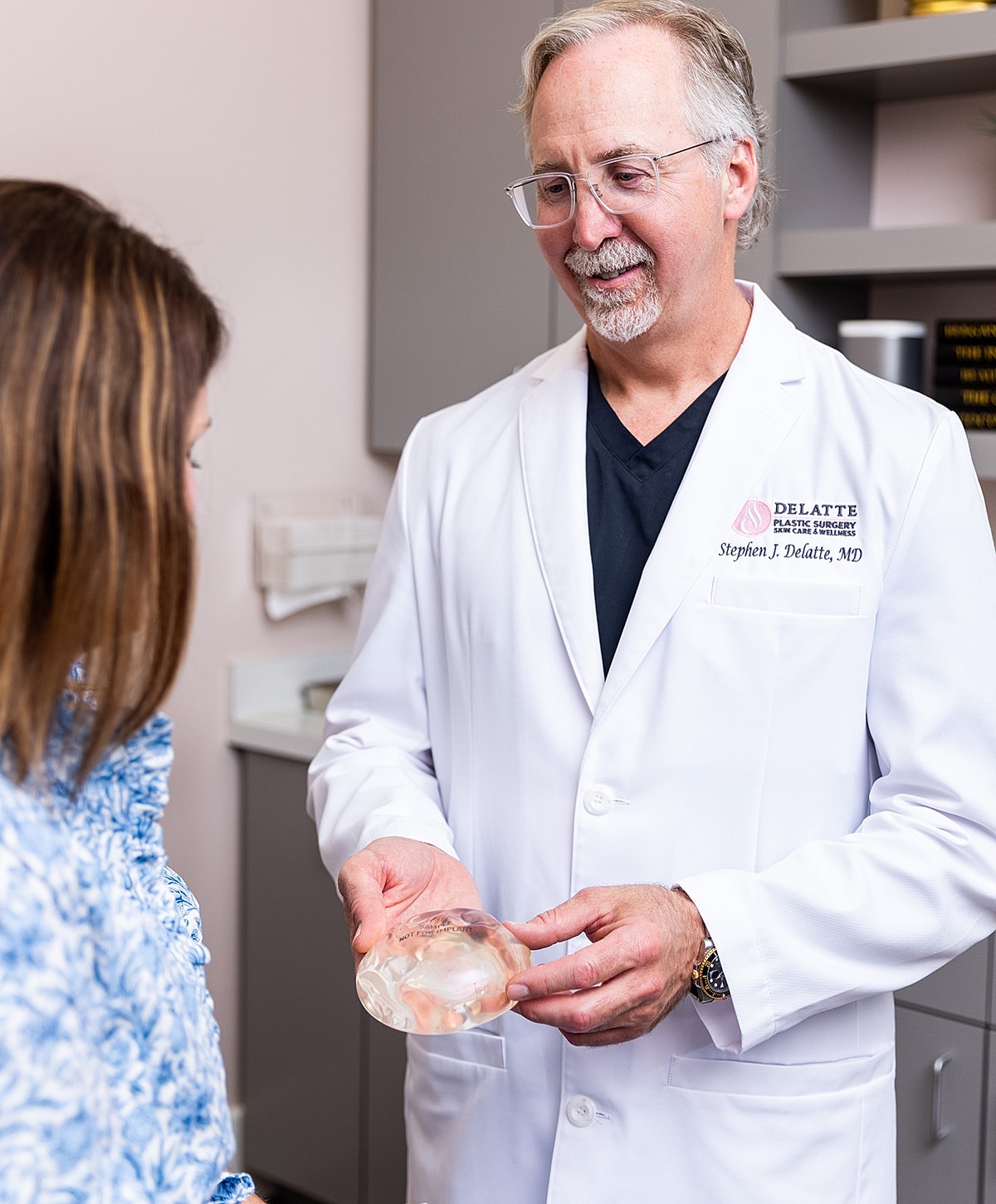 Dr. Delatte discussing breast implant options with patient.