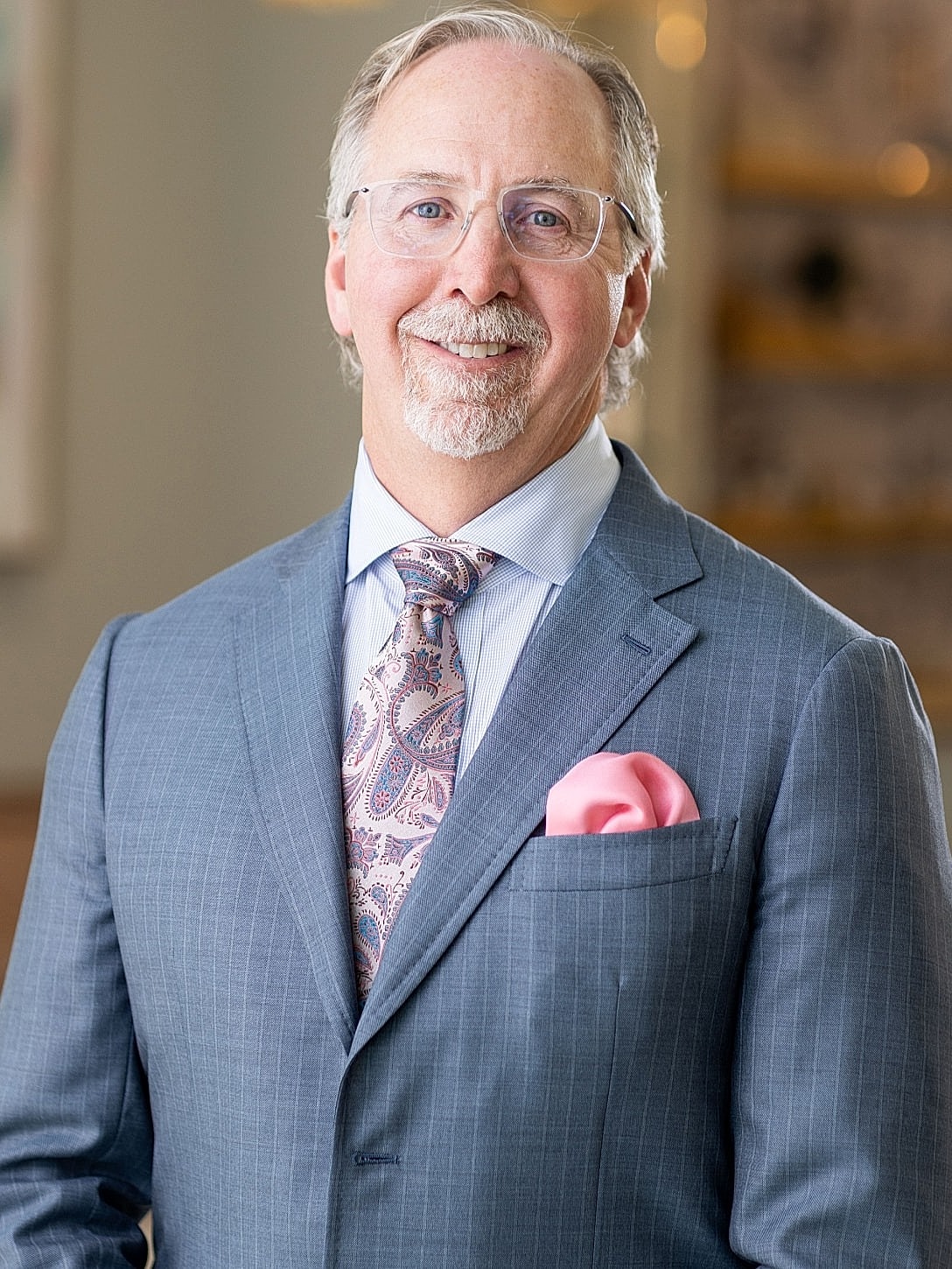 Male doctor smiling in professional attire.