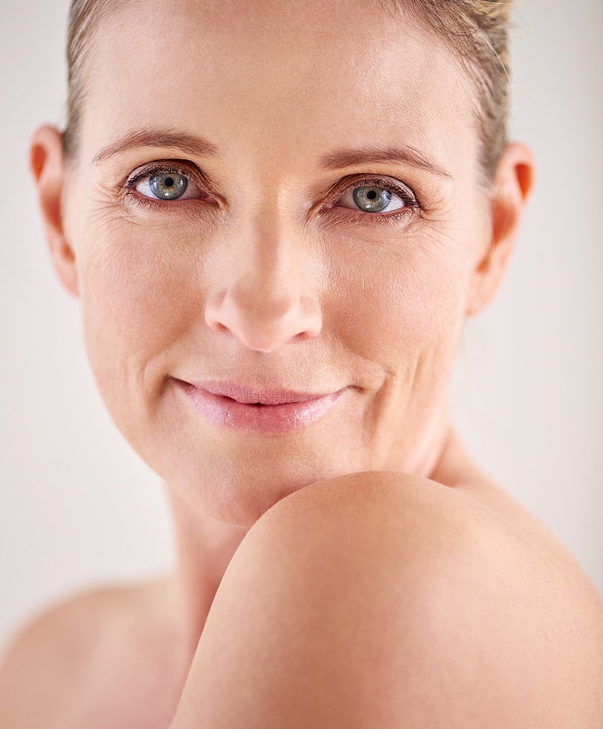 Close-up of smiling Lafayette blepharoplasty model with natural beauty.