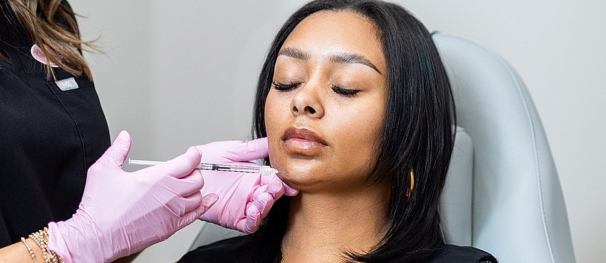 Receiving a cosmetic treatment in a clinic.