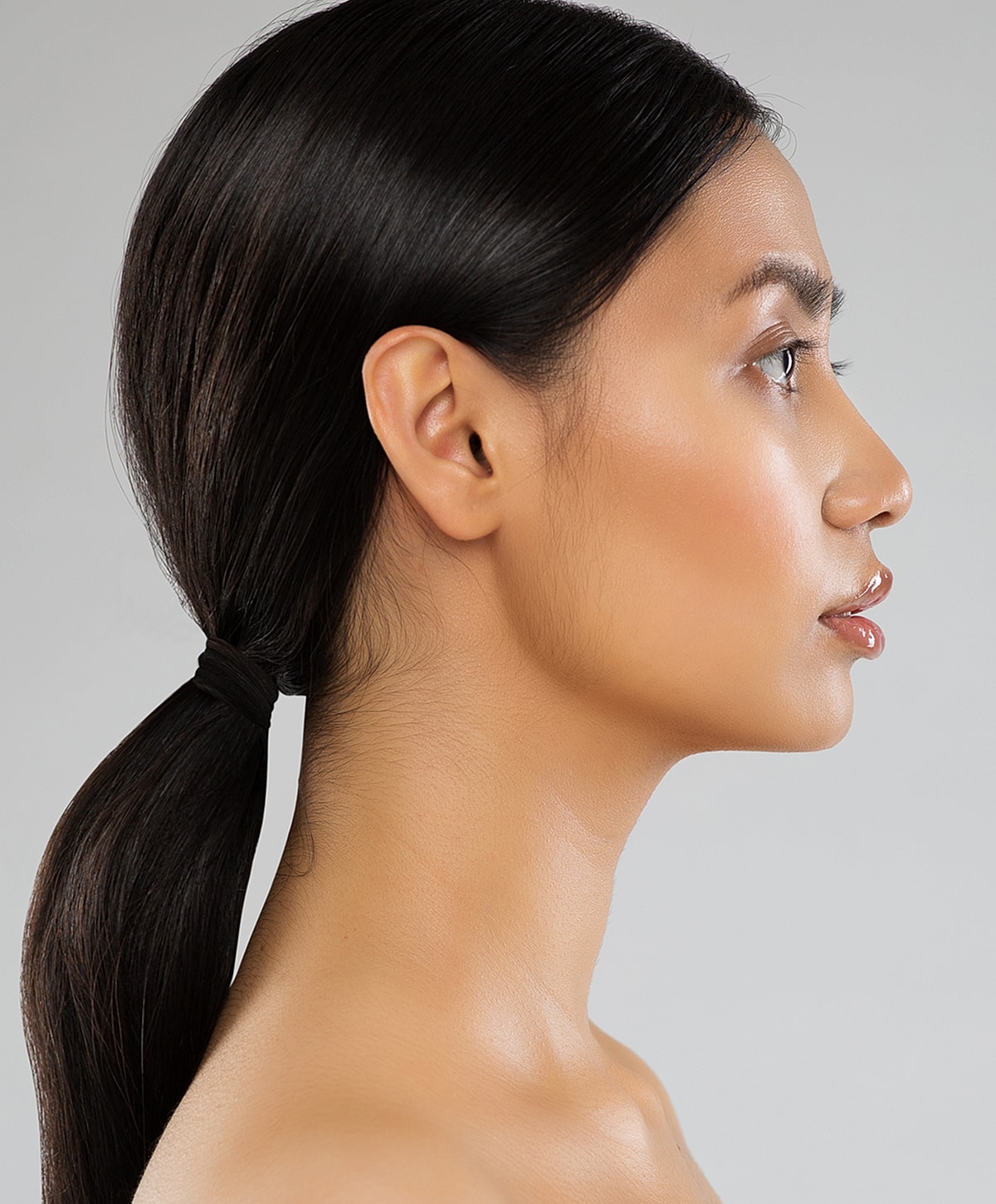 Profile view of a woman with sleek hair.