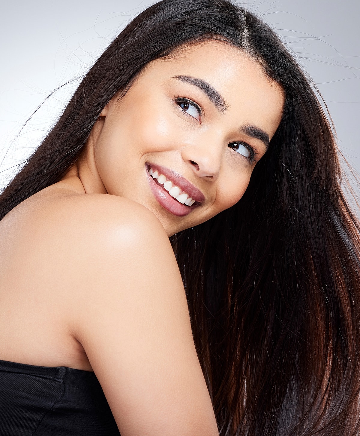 Smiling young woman with long, dark hair.