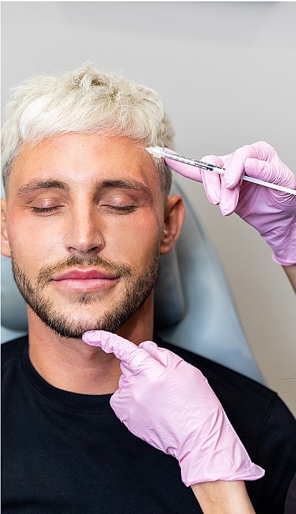 Man receiving cosmetic treatment with injected syringe.