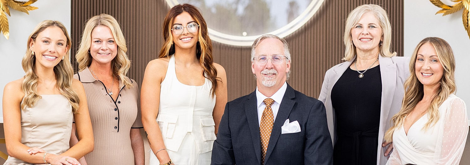 Professional group portrait in elegant setting.
