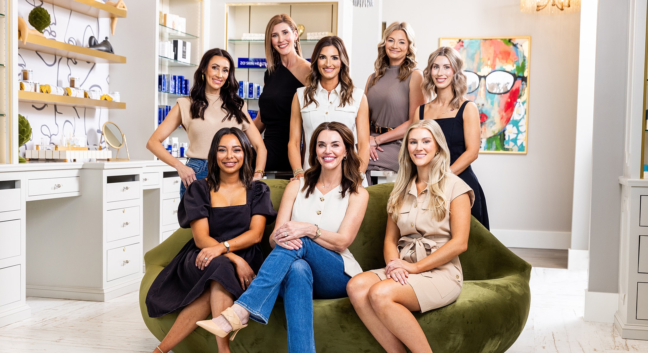 Group of women smiling in a modern setting.