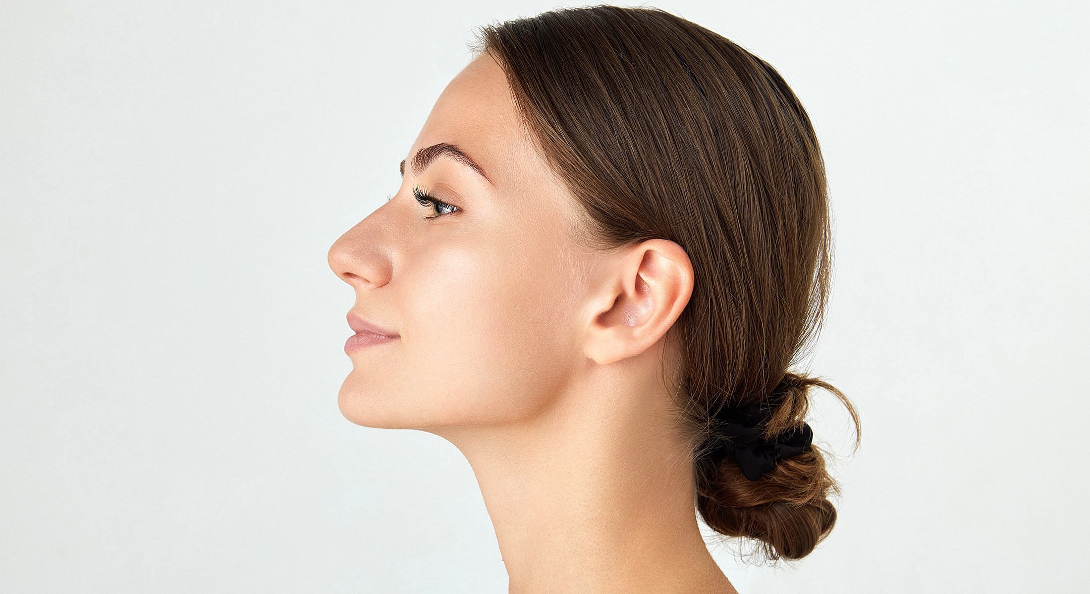 Woman with long hair and soft makeup.