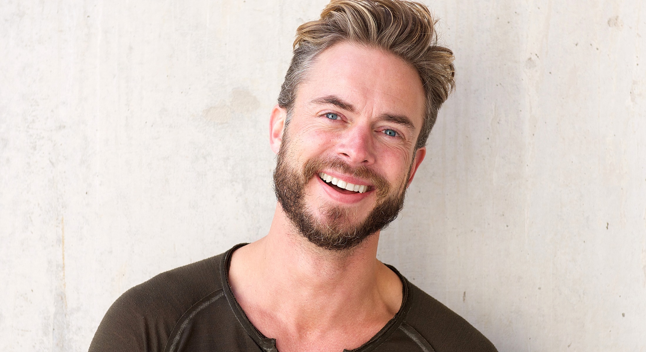 Lafayette Botox for men model with beard against concrete background.